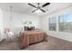 Bedroom with hanging chair, ceiling fan, and neutral tones at 19641 E Emperor Blvd, Queen Creek, AZ 85142