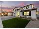 Two-story house with artificial turf, a brick driveway, and a covered entryway at 19641 E Emperor Blvd, Queen Creek, AZ 85142