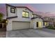 Two-story house with a three-car garage, landscaping, and a brick driveway at 19641 E Emperor Blvd, Queen Creek, AZ 85142
