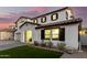 Two-story house with artificial turf and a covered entryway at dusk at 19641 E Emperor Blvd, Queen Creek, AZ 85142