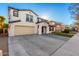 Two-story house with a three-car garage and a landscaped front yard at 19641 E Emperor Blvd, Queen Creek, AZ 85142