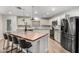 Modern kitchen featuring an island, stainless steel appliances, and hardwood floors at 19641 E Emperor Blvd, Queen Creek, AZ 85142
