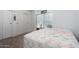 Second bedroom with a floral patterned bedspread and ample closet space at 205 S Higley Rd # 32, Mesa, AZ 85206