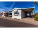 Single-wide manufactured home with carport and landscaping at 205 S Higley Rd # 32, Mesa, AZ 85206