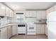 View of kitchen with white appliances and light cabinets at 205 S Higley Rd # 32, Mesa, AZ 85206