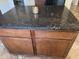 Kitchen island with dark granite countertop at 2114 N 94Th Ave, Phoenix, AZ 85037