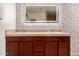 Double vanity bathroom with stylish wallpaper and updated lighting at 2146 E Whitton Ave, Phoenix, AZ 85016