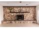 Large stone fireplace as a focal point in the living room at 2146 E Whitton Ave, Phoenix, AZ 85016