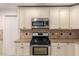 Kitchen features stainless steel appliances and granite countertops at 2146 E Whitton Ave, Phoenix, AZ 85016