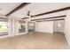 Open living space with wood beams, tile floors, and pool view at 2146 E Whitton Ave, Phoenix, AZ 85016