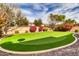 Putting green and backyard with lush landscaping at 3016 E Maplewood St, Gilbert, AZ 85297