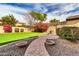 Landscaped backyard with putting green and brick pathway at 3016 E Maplewood St, Gilbert, AZ 85297