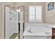 Clean bathroom with shower and garden tub at 3016 E Maplewood St, Gilbert, AZ 85297