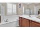 Spa-like bathroom with soaking tub and walk-in shower at 3016 E Maplewood St, Gilbert, AZ 85297