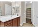 Bathroom with vanity, sink, and large walk-in closet at 3016 E Maplewood St, Gilbert, AZ 85297
