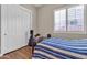 Cozy bedroom with wood flooring and window at 3016 E Maplewood St, Gilbert, AZ 85297