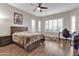Comfortable bedroom with wood floors and a ceiling fan at 3016 E Maplewood St, Gilbert, AZ 85297