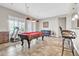 Game room with pool table, bar stools, and seating at 3016 E Maplewood St, Gilbert, AZ 85297