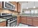Modern kitchen with stainless steel appliances and granite countertops at 3016 E Maplewood St, Gilbert, AZ 85297