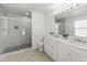 Modern bathroom with marble vanity, large shower, and wood-look flooring at 3127 W Maya Way, Phoenix, AZ 85083