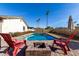 Inviting backyard oasis featuring a sparkling pool, fire pit, and comfortable seating at 3921 E Shaw Butte Dr, Phoenix, AZ 85028