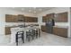 Modern kitchen with island, stainless steel appliances, and breakfast bar at 3986 S 178Th Ln, Goodyear, AZ 85338