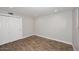 Simple bedroom with double doors and wood flooring at 6402 N 45Th Ave, Glendale, AZ 85301