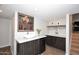 Modern wet bar with cabinetry, wine storage, and sink at 6402 N 45Th Ave, Glendale, AZ 85301