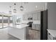 Modern kitchen with island, gray cabinets, and stainless steel appliances at 779 S La Mesa Ct, Casa Grande, AZ 85122