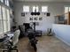 Living room with large windows, motorcycle, and home office setup at 8605 W Carole Ln, Glendale, AZ 85305