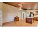 Dining area with wood floors, ceiling fan and view of kitchen at 8873 N 114Th Dr, Peoria, AZ 85345