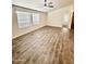 Living room with wood-look floors, large windows, and neutral decor at 9333 E University Dr # 51, Mesa, AZ 85207