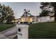 Bright white home with palm trees and a long driveway at 9440 N 57Th St, Paradise Valley, AZ 85253