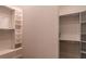 Bright walk-in closet with built-in shelving and hanging rods at 9440 N 57Th St, Paradise Valley, AZ 85253