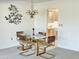 Dining room with glass table, chandelier, and access to kitchen at 10626 W Mission Ln, Sun City, AZ 85351