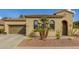 Tan house with two-car garage and desert landscaping at 12448 W Rosewood Ln, Peoria, AZ 85383