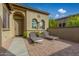 Private courtyard with brick pavers and modern lounge chairs at 12448 W Rosewood Ln, Peoria, AZ 85383