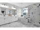 Elegant bathroom with marble tile and soaking tub at 12527 W Sierra Vista Ct, Glendale, AZ 85307