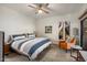 Spacious bedroom with king bed, orange accent chair, and tiled floors at 15050 N Thompson Peak Pkwy # 2053, Scottsdale, AZ 85260