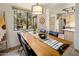 Dining area with a wooden table, black chairs and a view into the kitchen at 15050 N Thompson Peak Pkwy # 2053, Scottsdale, AZ 85260