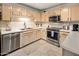 Well-equipped kitchen with light wood cabinets, stainless steel appliances, and a double sink at 15050 N Thompson Peak Pkwy # 2053, Scottsdale, AZ 85260