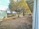 Large backyard with mature trees and desert landscaping at 2127 E Bayberry Ave, Mesa, AZ 85204