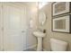 Powder room with pedestal sink and framed art at 25803 N 8Th Ave, Phoenix, AZ 85085