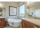 Bathroom with double vanity, large soaking tub and a window at 25803 N 8Th Ave, Phoenix, AZ 85085