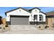 One-story home with gray garage door and desert landscaping at 40030 W Venture Rd, Maricopa, AZ 85138
