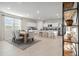 Bright kitchen with island, stainless steel appliances, and wooden dining table at 40030 W Venture Rd, Maricopa, AZ 85138