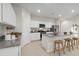 Modern kitchen with white cabinets, granite countertops, and stainless steel appliances at 40030 W Venture Rd, Maricopa, AZ 85138