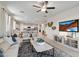 Spacious living room with open floor plan and large TV at 40030 W Venture Rd, Maricopa, AZ 85138