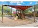 Shaded playground with climbing structures and slide at 40030 W Venture Rd, Maricopa, AZ 85138