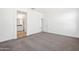 Spacious bedroom with carpet flooring and access to bathroom at 40080 W Venture Rd, Maricopa, AZ 85138